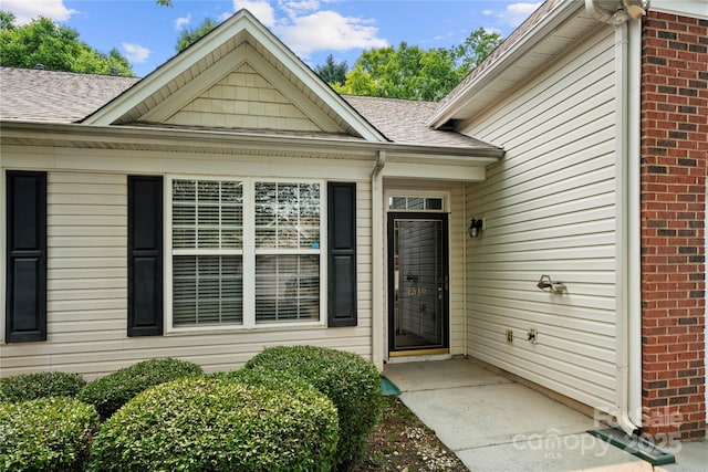 4510 Glenlea Commons Dr, Charlotte, NC 28216 - property entrance featuring a shingled roof and brick siding