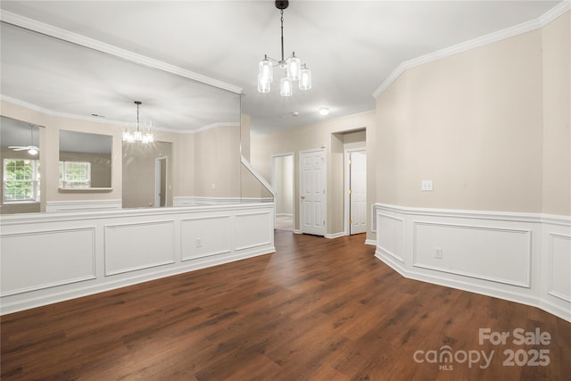 4510 Glenlea Commons Dr, Charlotte, NC 28216 - empty room with a chandelier, dark wood-type flooring, crown molding, a decorative wall, and a wainscoted wall