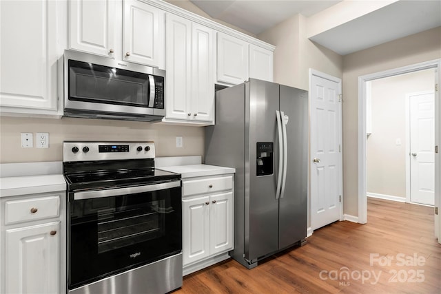 4510 Glenlea Commons Dr, Charlotte, NC 28216 - kitchen featuring stainless steel appliances, wood finished floors, white cabinetry, and light countertops