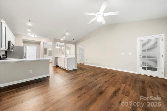 4510 Glenlea Commons Dr, Charlotte, NC 28216 - unfurnished living room featuring lofted ceiling, a sink, a ceiling fan, dark wood-style flooring, and baseboards