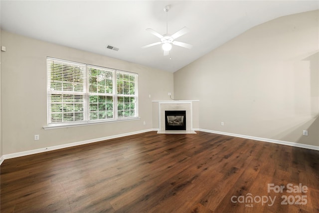 4510 Glenlea Commons Dr, Charlotte, NC 28216 - unfurnished living room featuring vaulted ceiling, ceiling fan, dark wood-style flooring, a fireplace, and baseboards