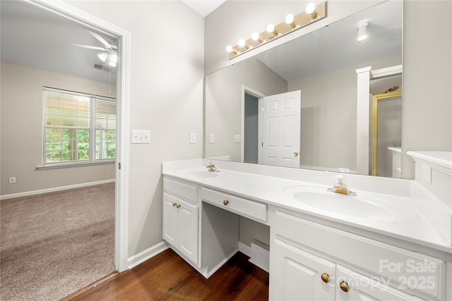 4510 Glenlea Commons Dr, Charlotte, NC 28216 - bathroom featuring double vanity, ceiling fan, baseboards, and wood finished floors
