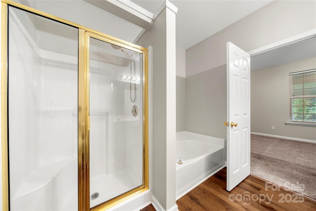 4510 Glenlea Commons Dr, Charlotte, NC 28216 - bathroom featuring a bath, a shower stall, wood finished floors, and baseboards