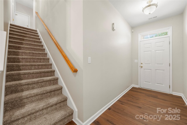 4510 Glenlea Commons Dr, Charlotte, NC 28216 - foyer entrance featuring stairway, dark wood-type flooring, and baseboards