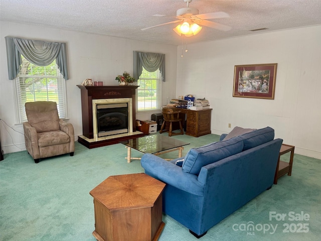 8616 Fallsdale Dr, Charlotte, NC 28214 - carpeted living area featuring a textured ceiling, a ceiling fan, and a fireplace with raised hearth