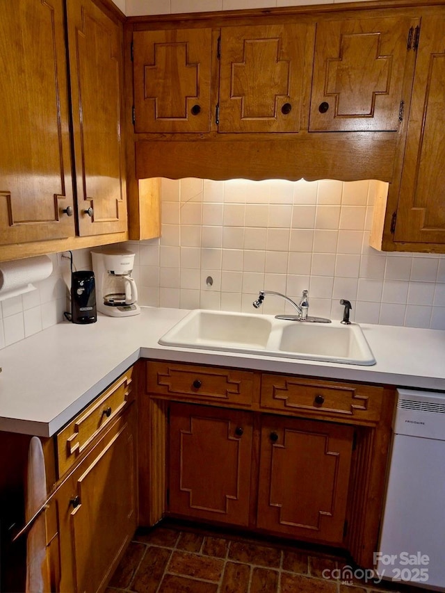 8616 Fallsdale Dr, Charlotte, NC 28214 - kitchen featuring dishwasher, light countertops, brown cabinets, and backsplash