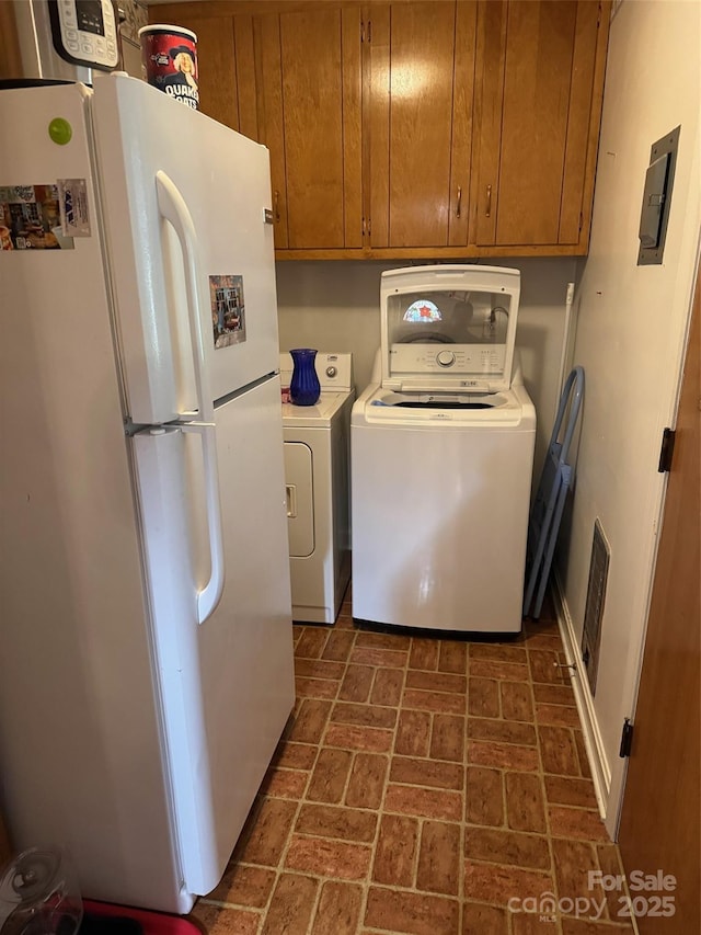 8616 Fallsdale Dr, Charlotte, NC 28214 - laundry area with brick patterned flooring, washer and clothes dryer, cabinet space, and electric panel