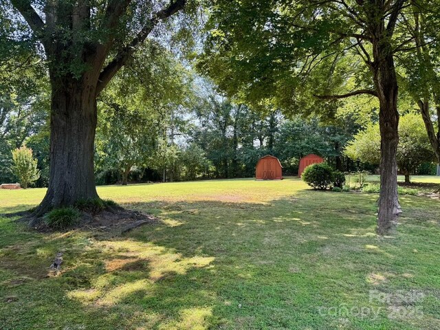 8616 Fallsdale Dr, Charlotte, NC 28214 - view of green lawn with a barn and an outdoor structure