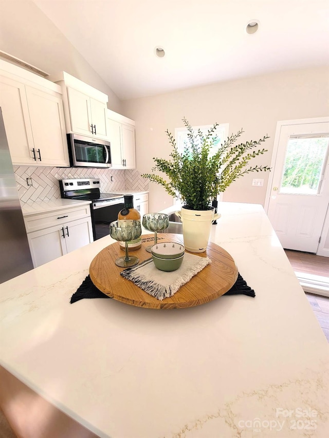 102 Lakeside Dr, Grover, NC 28073 - kitchen featuring appliances with stainless steel finishes, backsplash, white cabinets, recessed lighting, and light stone counters