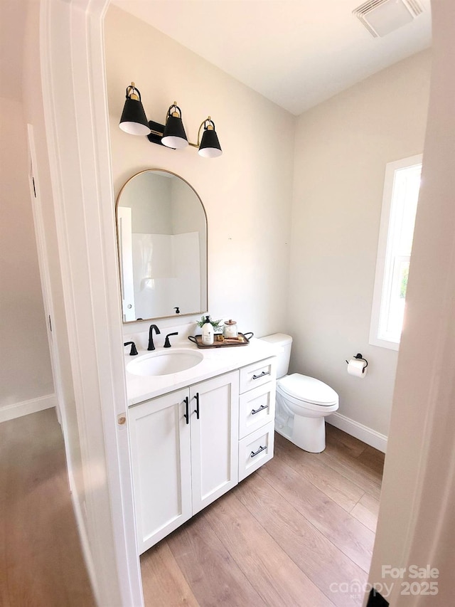 102 Lakeside Dr, Grover, NC 28073 - bathroom featuring vanity, wood finished floors, toilet, and baseboards