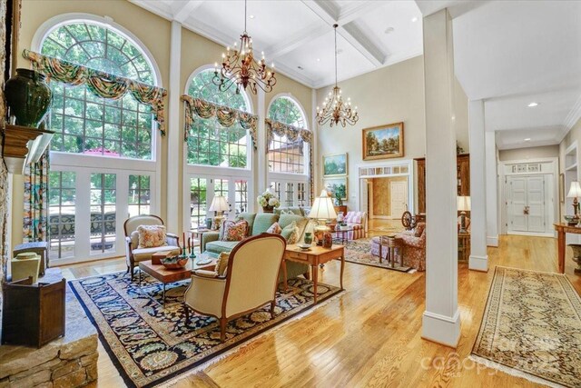 517 Kingsdown Ct, Waxhaw, NC 28173 - living room featuring a towering ceiling, coffered ceiling, beamed ceiling, wood finished floors, and crown molding