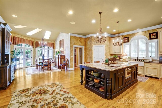 517 Kingsdown Ct, Waxhaw, NC 28173 - kitchen with a chandelier, dark brown cabinets, a center island with sink, light stone countertops, and open shelves