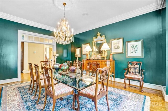 517 Kingsdown Ct, Waxhaw, NC 28173 - dining area with a chandelier, wood finished floors, and ornamental molding