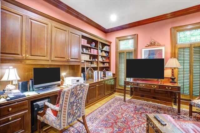 517 Kingsdown Ct, Waxhaw, NC 28173 - home office with built in desk, crown molding, light wood-style flooring, and plenty of natural light