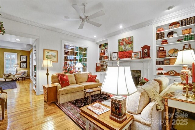 517 Kingsdown Ct, Waxhaw, NC 28173 - living area featuring light wood-style flooring, a ceiling fan, plenty of natural light, ornamental molding, and recessed lighting