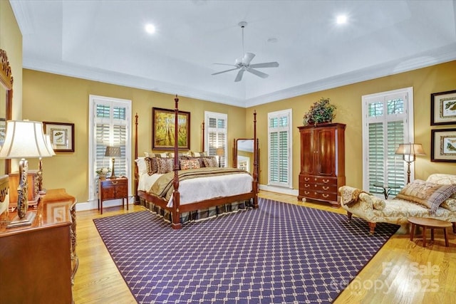 517 Kingsdown Ct, Waxhaw, NC 28173 - bedroom with light wood-type flooring, a raised ceiling, crown molding, and recessed lighting