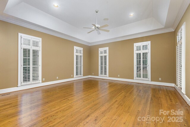 517 Kingsdown Ct, Waxhaw, NC 28173 - empty room featuring a tray ceiling, ceiling fan, wood finished floors, crown molding, and recessed lighting
