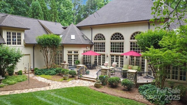 517 Kingsdown Ct, Waxhaw, NC 28173 - rear view of property featuring stucco siding, french doors, and roof with shingles