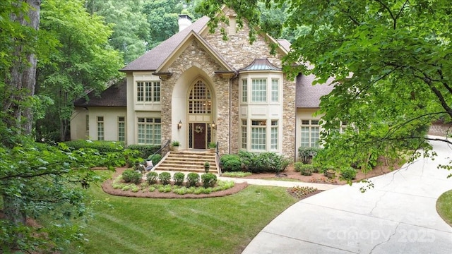 517 Kingsdown Ct, Waxhaw, NC 28173 - view of front of home with a chimney, stone siding, a front yard, and stucco siding