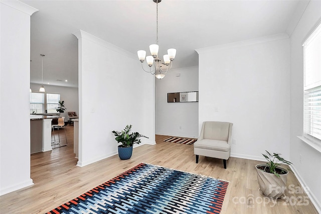13140 Sudwick Ln, Charlotte, NC 28278 - sitting room with light wood finished floors, a chandelier, baseboards, and ornamental molding