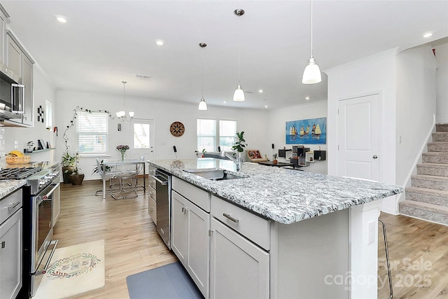 13140 Sudwick Ln, Charlotte, NC 28278 - kitchen with a sink, stainless steel appliances, gray cabinets, light wood-style flooring, and recessed lighting