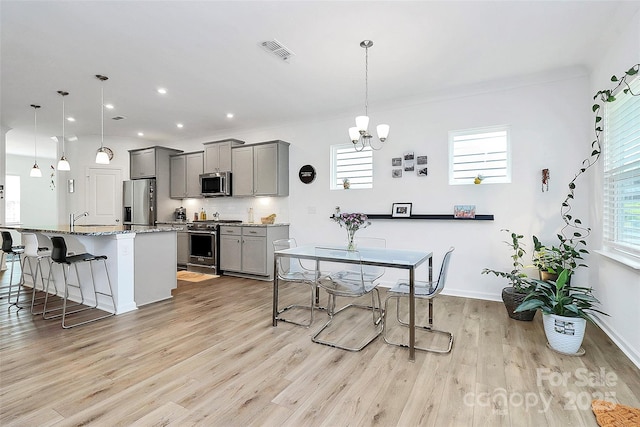 13140 Sudwick Ln, Charlotte, NC 28278 - dining space with a chandelier, light wood finished floors, plenty of natural light, recessed lighting, and baseboards