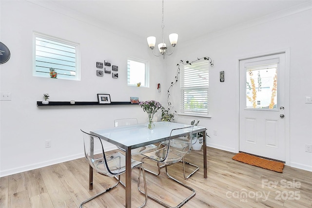 13140 Sudwick Ln, Charlotte, NC 28278 - dining area featuring light wood-style flooring, a chandelier, and baseboards