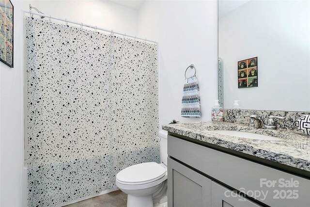 13140 Sudwick Ln, Charlotte, NC 28278 - bathroom with vanity, toilet, a shower with shower curtain, and tile patterned flooring