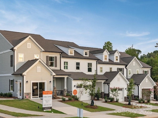 12016 Basking Dr, Charlotte, NC 28214 - townhome / multi-family property with a garage, a residential view, concrete driveway, and stone siding