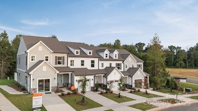 12016 Basking Dr, Charlotte, NC 28214 - multi unit property with driveway, stone siding, and an attached garage