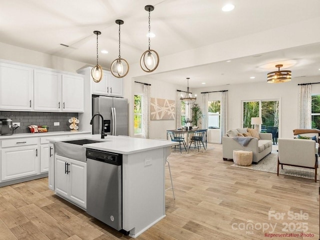 12016 Basking Dr, Charlotte, NC 28214 - kitchen featuring appliances with stainless steel finishes, a sink, backsplash, light countertops, and recessed lighting