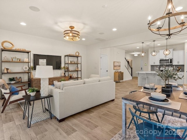 12016 Basking Dr, Charlotte, NC 28214 - living area with a chandelier, light wood finished floors, stairs, recessed lighting, and baseboards