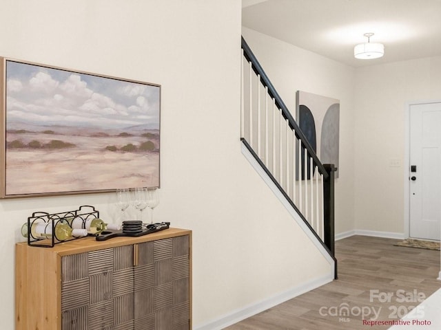 12016 Basking Dr, Charlotte, NC 28214 - foyer with wood finished floors, baseboards, and stairway