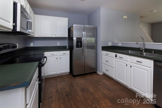 7623 Monarch Birch Ln, Charlotte, NC 28215 - kitchen featuring appliances with stainless steel finishes, a sink, dark countertops, and dark wood-type flooring