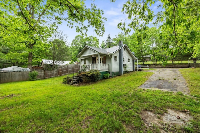 220 W College St, Black Mountain, NC 28711 - view of home's exterior with covered porch, a chimney, and a metal roof