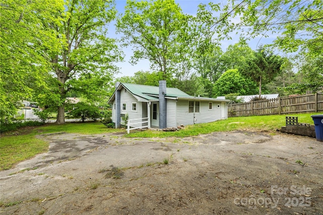 220 W College St, Black Mountain, NC 28711 - rear view of house featuring a metal roof and a chimney