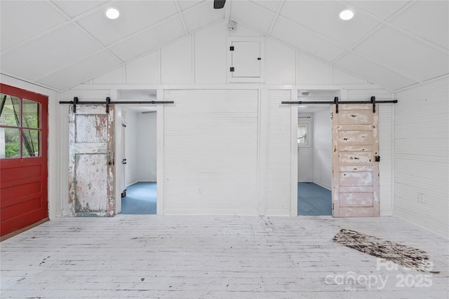 220 W College St, Black Mountain, NC 28711 - unfurnished bedroom with a barn door, wood finished floors, lofted ceiling, and recessed lighting