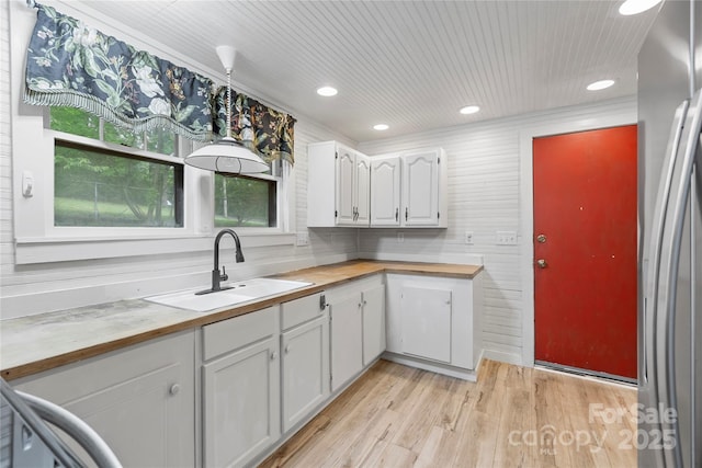 220 W College St, Black Mountain, NC 28711 - kitchen with wooden counters, white cabinets, light wood-style floors, stainless steel fridge, and recessed lighting