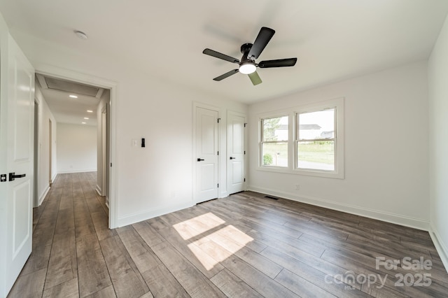 3608 Crestridge Dr, Charlotte, NC 28217 - unfurnished bedroom with dark wood-style floors, attic access, and baseboards