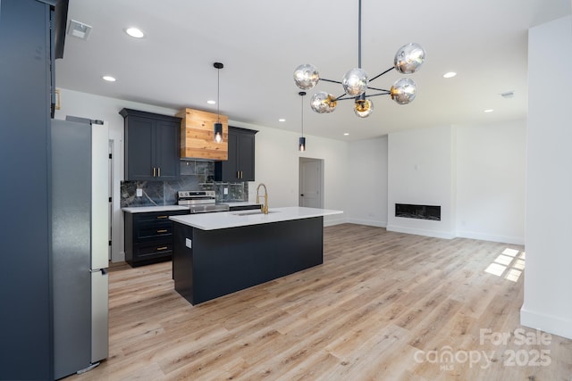 1520 Enochville Rd, Kannapolis, NC 28081 - kitchen featuring appliances with stainless steel finishes, light countertops, backsplash, light wood-style floors, and recessed lighting