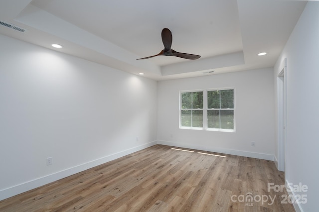 1520 Enochville Rd, Kannapolis, NC 28081 - unfurnished room with a tray ceiling, a ceiling fan, recessed lighting, light wood-type flooring, and baseboards