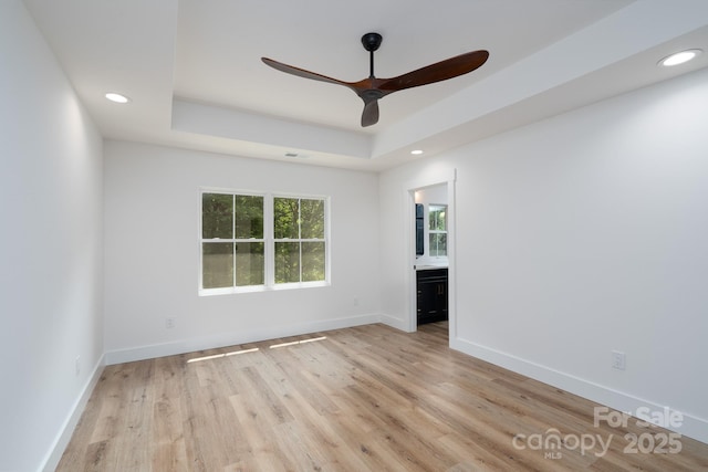 1520 Enochville Rd, Kannapolis, NC 28081 - empty room with ceiling fan, a raised ceiling, light wood-style floors, recessed lighting, and baseboards