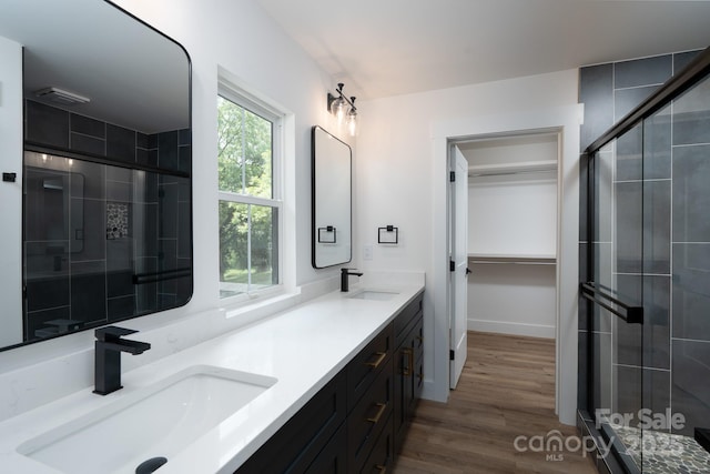 1520 Enochville Rd, Kannapolis, NC 28081 - bathroom featuring double vanity, a shower stall, and wood finished floors