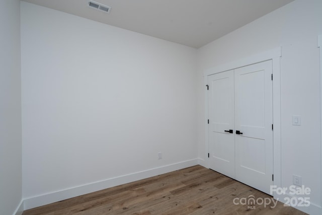 1520 Enochville Rd, Kannapolis, NC 28081 - unfurnished bedroom featuring wood finished floors, baseboards, and a closet