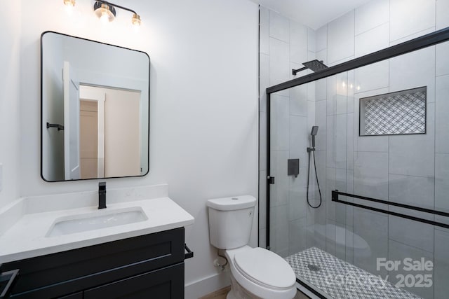 1520 Enochville Rd, Kannapolis, NC 28081 - bathroom featuring toilet, vanity, and a stall shower