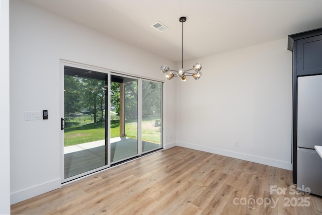 1520 Enochville Rd, Kannapolis, NC 28081 - unfurnished dining area featuring light wood-style flooring, a chandelier, and baseboards