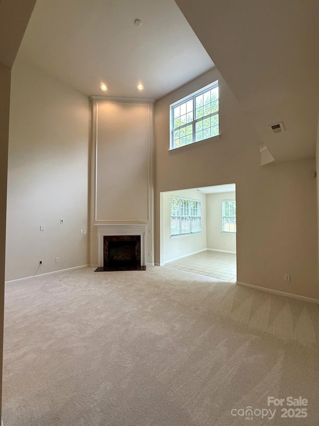 1304 Ridge Haven Rd, Waxhaw, NC 28173 - unfurnished living room with carpet, baseboards, a fireplace, plenty of natural light, and recessed lighting
