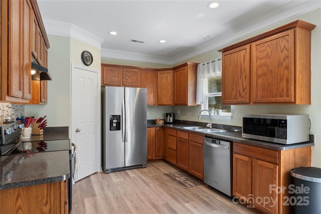 4006 Centerview Dr, Indian Trail, NC 28079 - kitchen with appliances with stainless steel finishes, a sink, brown cabinetry, crown molding, and light wood-style floors