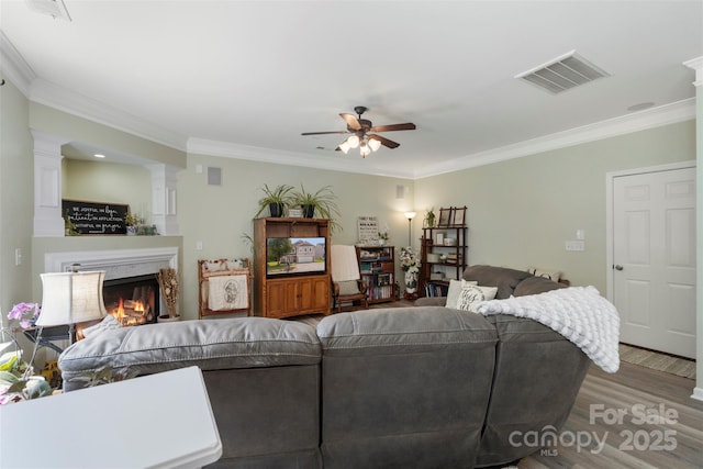 4006 Centerview Dr, Indian Trail, NC 28079 - living area with a ceiling fan, wood finished floors, ornamental molding, a premium fireplace, and decorative columns