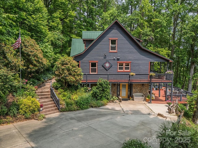 2981 Heath Peak Rd, Waynesville, NC 28785 - view of front of home with stairs, concrete driveway, a patio, stone siding, and a deck